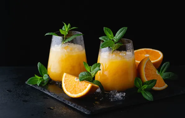 The dark background, ice, oranges, glasses, juice, cocktail, glasses, cold