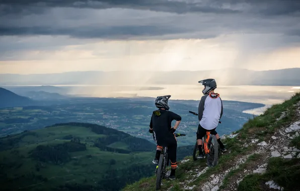 Mountains, clouds, valley, cyclists, pond