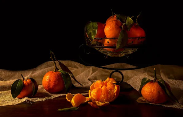 Table, black background, stand, slices, peel, tangerines, vase, gauze