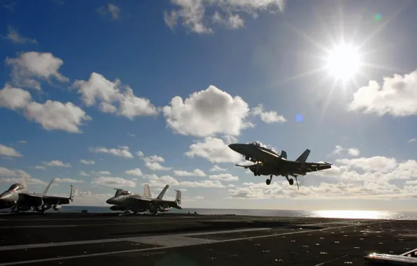 Picture the sun, clouds, fighter, the carrier, landing