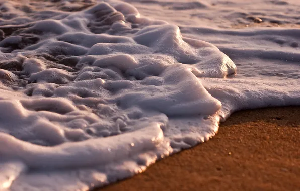 Sand, sea, foam, water, macro photo