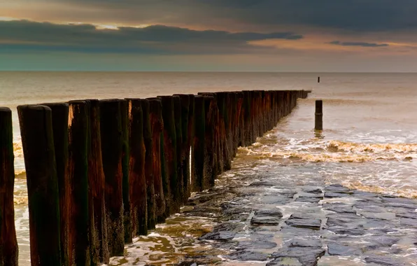 Picture sea, stones, posts, a number, stones