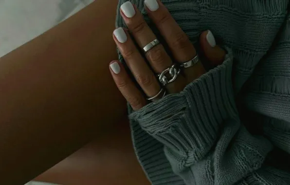 Girl, manicure, slender legs, tanned legs, rings on the fingers