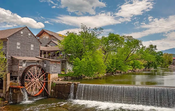 The sky, trees, house, river, wheel, water mill