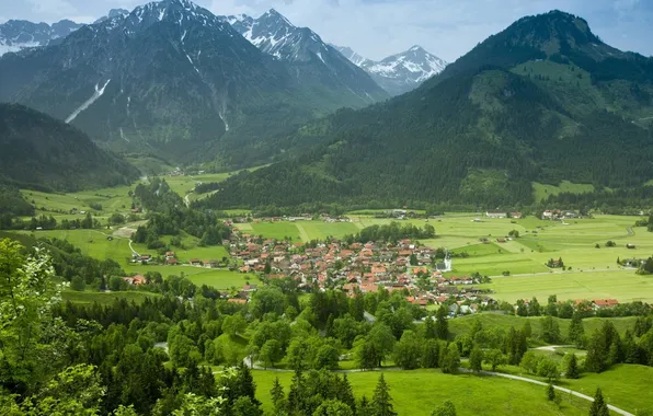 Greens, mountains, village