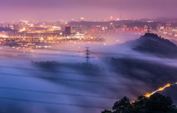 The sky, trees, the city, lights, fog, hills, wire, view