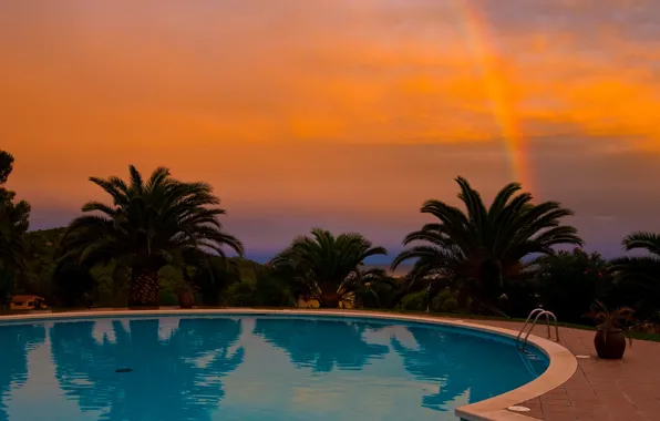 Picture sunset, palm trees, rainbow, pool