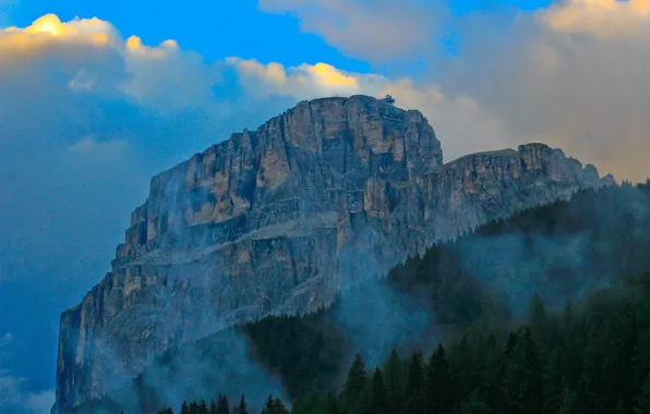The sky, clouds, trees, fog, rock, mountain