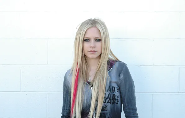Picture Girl, Avril Lavigne, looking at the camera, famous rock singer, standing over a white wall, …