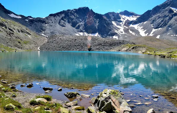 The sky, clouds, mountains, lake, stones