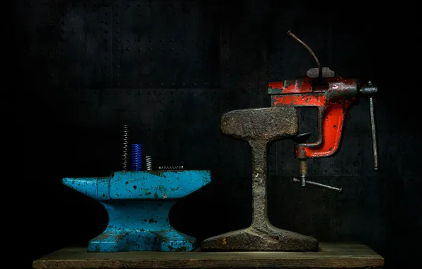 Black background, anvil, vise
