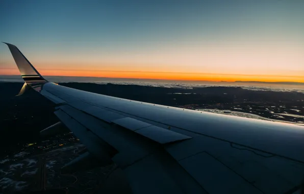 The sky, clouds, the plane, wing, horizon