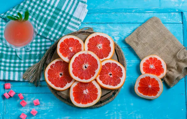 Glass, candy, blue background, grapefruit