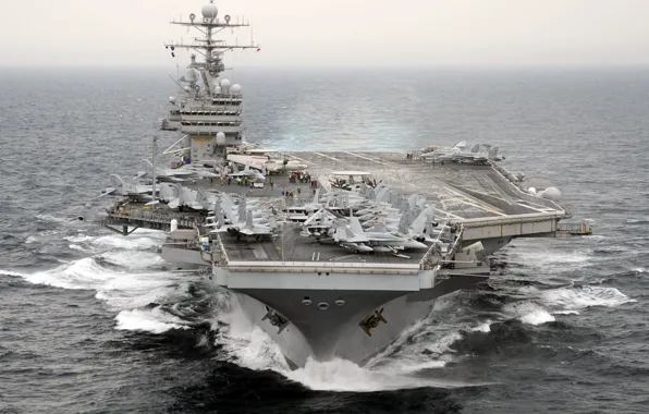 Picture the ocean, fighters, the carrier, deck, Multipurpose, type "Nimitz", with nuclear power, number CVN-71