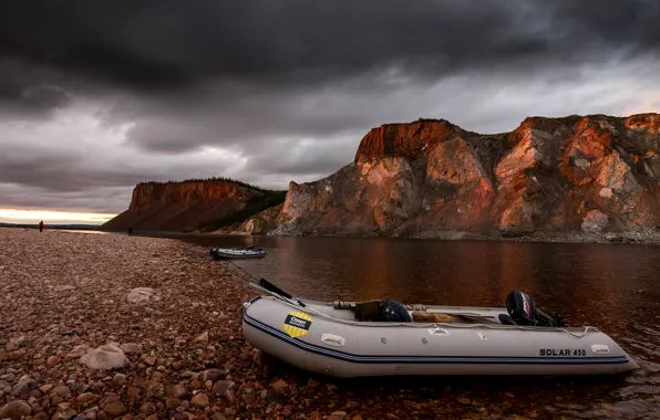 The sky, mountains, clouds, river, stones, shore, boat, people