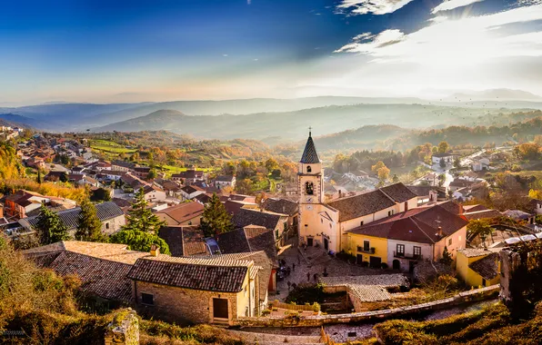 The sky, the sun, clouds, hills, bird, valley, village, horizon