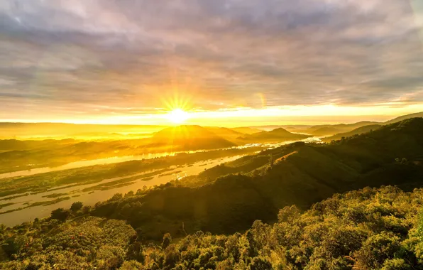 The sky, the sun, clouds, rays, light, trees, mountains, yellow