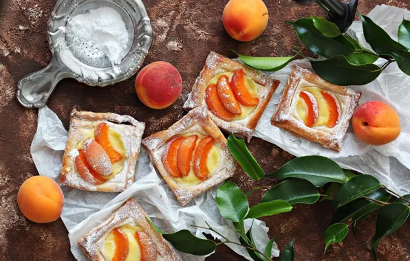 Picture pie, cream, cakes, apricots, powdered sugar, the pieces of the pie