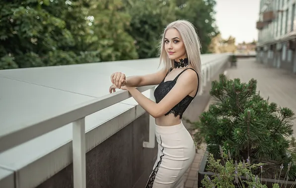 Smile, blonde, model posing, black top, white trousers