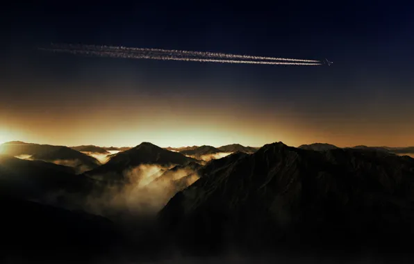 The sun, mountains, fog, dawn, the plane