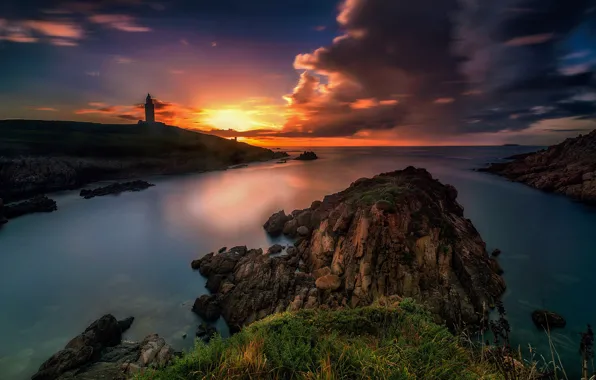 Sea, clouds, sunset, stones, rocks, shore, lighthouse, bright colors