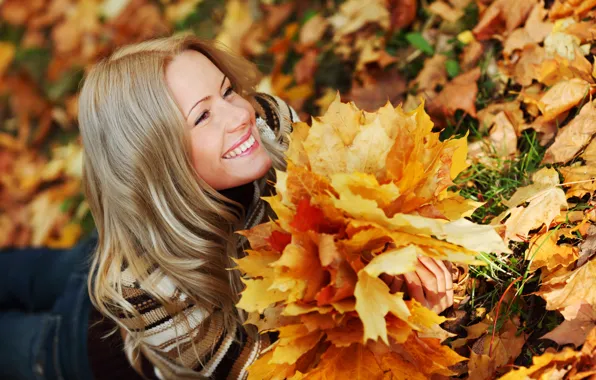 Picture autumn, grass, look, leaves, girl, smile, jeans, blonde, lies, sweater