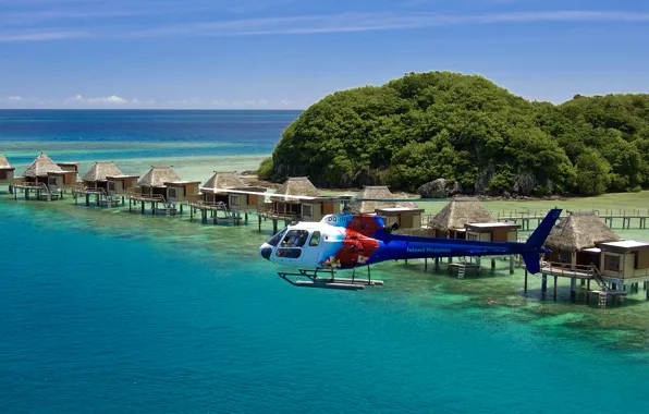 Picture the ocean, shore, the hotel, helicopter