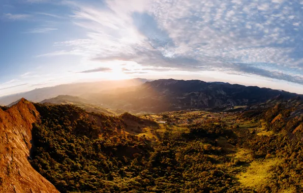 The sky, clouds, trees, mountains, sky, trees, mountains, clouds