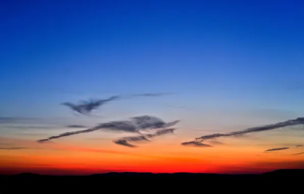 The sky, clouds, mountains, horizon, glow