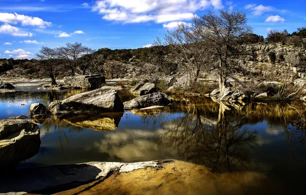 The sky, trees, lake, stones, rocks