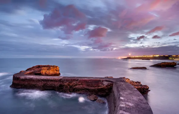 Sea, lights, shore, the evening