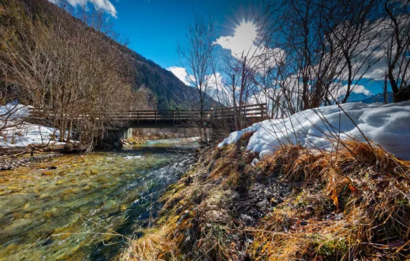 The sky, the sun, clouds, rays, snow, trees, bridge, mountain