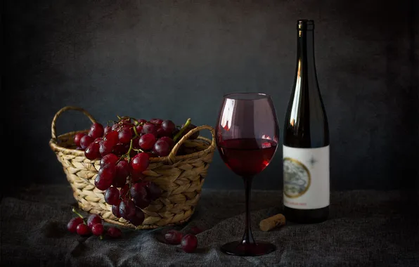 The dark background, table, wine, glass, bottle, grapes, tube, basket