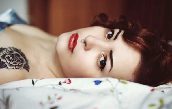 Tattoo, piercing, red head, septum, laying down