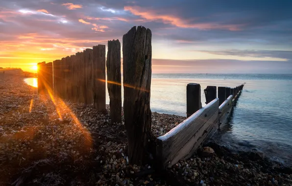 Sea, sunset, shore, posts, the fence, piles