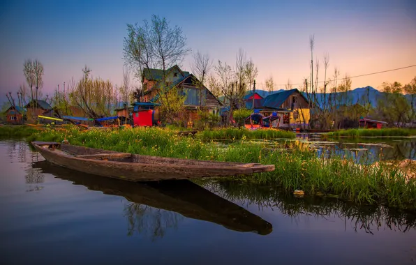 Beautiful golden sunset view of Dal lake at Srinagar, Jammu and Kashmir.  Teal & orange wallpaper view with traditional Kashmiri Shikhara/boat.  Serene scene of Kashmir. Boating, recreation, fun. Stock Photo | Adobe