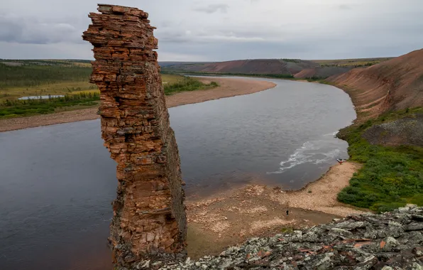 The sky, rock, lake, river, stones, people, shore, boat