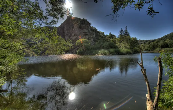 The sun, lake, glare, hills, dervla