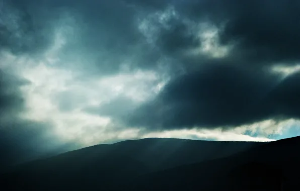 Picture landscape, mountains, clouds, darkness, a beam of light