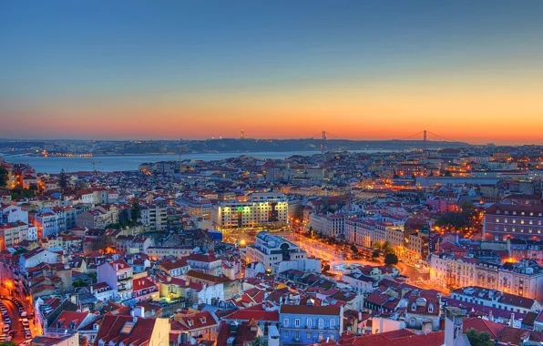 Beautiful vintage city of Lisbon with river, bridge and colorful sunset  evening sky with stars. Amazing starry sky. Space wallpaper Stock Photo