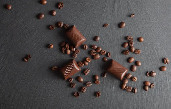 Chocolate, coffee beans, wooden background