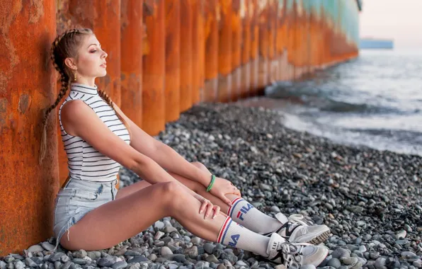 Sea, stones, brunette, sitting, white stockings, sneakers, jean shorts, women outdoors