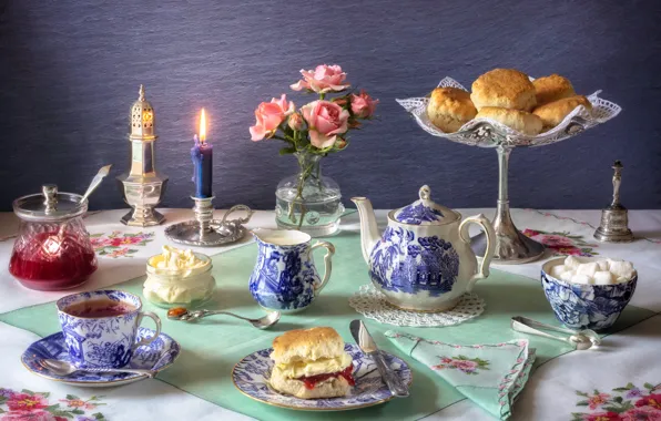 Tea, roses, candle, milk, cookies, dishes, sugar, still life