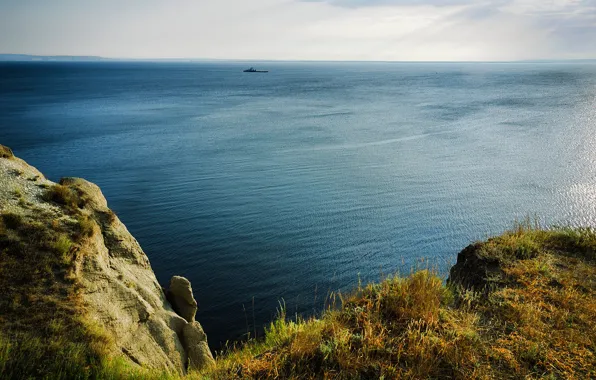The sky, grass, the sun, river, stones, rocks, shore, ship