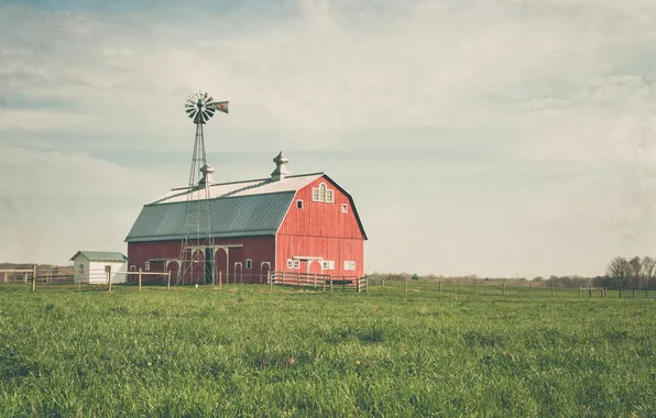 The sky, grass, clouds, the fence, field, the barn, windmill, farm