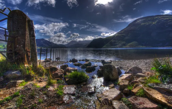 The sun, clouds, rays, mountains, lake