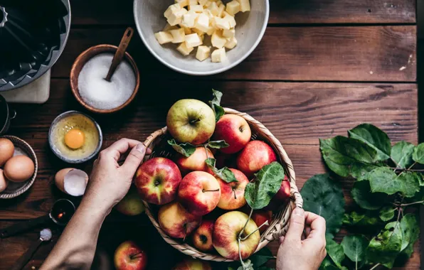Table, apples, oil, eggs, hands, sugar, basket