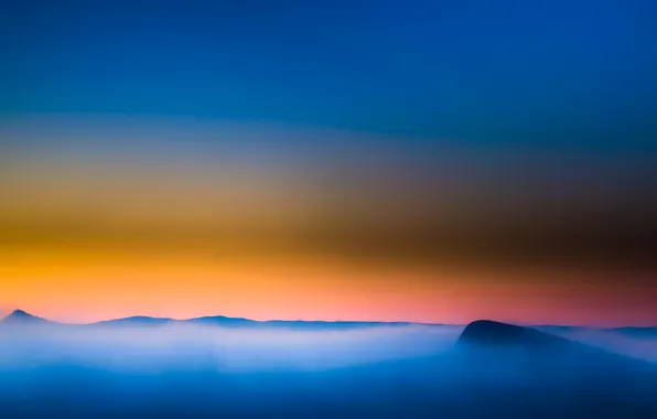 The sky, clouds, sunset, mountains, fog, top, glow