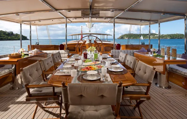 Breakfast, tables, chairs, cockpit, deck, Athos, luxury motor yacht Athos, Caribbean Sailing Charters