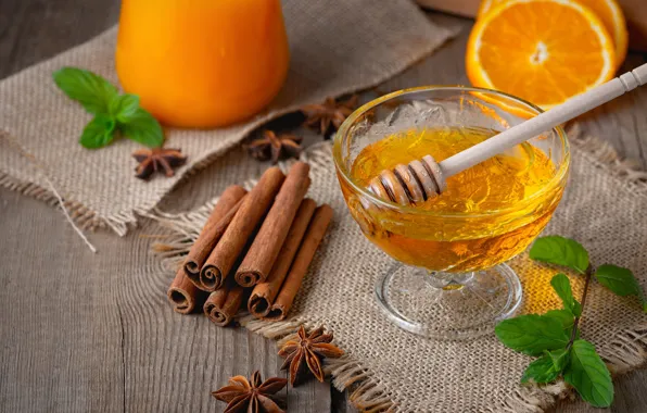 Glass, oranges, juice, spoon, honey, cinnamon, burlap, ramekin